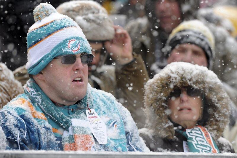 A visiting fan in Pittsburgh, Pennsylvania battles conditions to see the Miami Dolphins take on the Pittsburgh Steelers. Don Wright / AP
