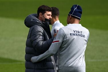 Paris Saint-Germain's Argentinian head coach  Mauricio Pochettino (L) speaks with Paris Saint-Germain's French forward Kylian Mbappe during a training session at the club's Camp des Loges training ground in Saint-Germain-en-Laye, west of Paris, on April 28, 2022.  (Photo by FRANCK FIFE  /  AFP)