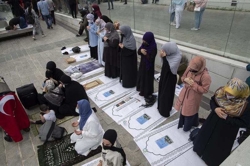 Women pray at the Friday prayer in front of the newly built Taksim Mosque at the Taksim Square. EPA