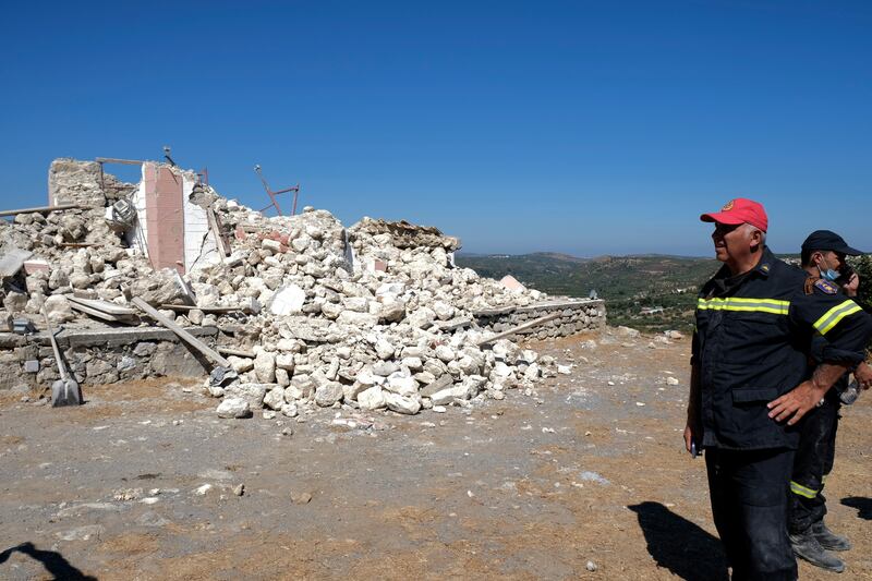 Firefighters stand next to the collapsed Greek Orthodox church of Profitis Ilias in Arkalochori village. Photo: AP