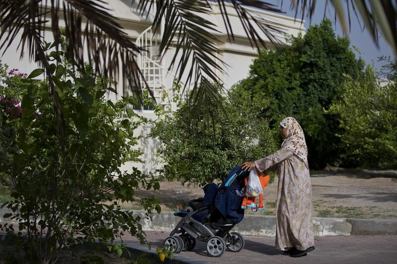United Arab Emirates -Dubai- May 15, 2009:

HOUSE & HOME: A nanny takes a child out for a stroll in the Nad Al Sheba neighborhood in Dubai on Friday, May 15, 2009. Amy Leang/The National
 *** Local Caption ***  amy_051509_nadalsheba_21.jpgamy_051509_nadalsheba_21.jpg