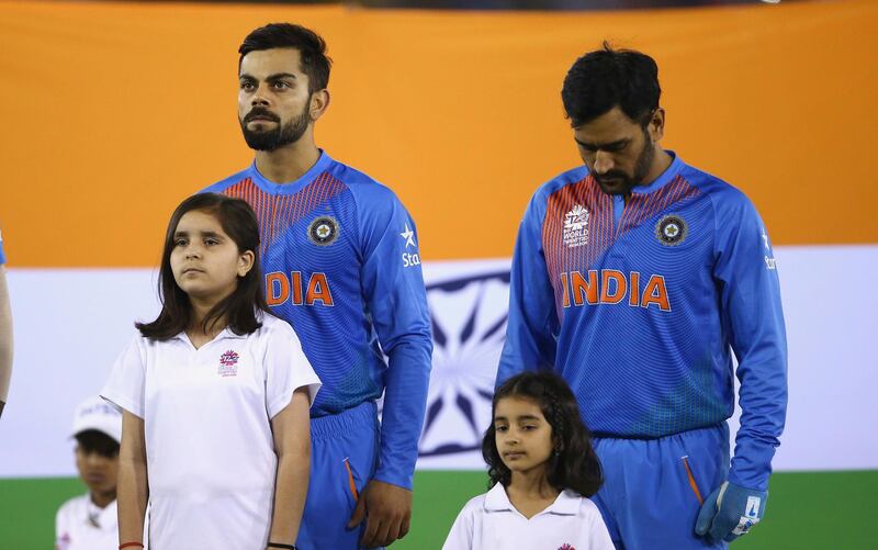 MOHALI, INDIA - MARCH 27:   Virat Kohli and MS Dhoni, Captain of India sing the anthem during the ICC WT20 India Group 2 match between India and Australia at I.S. Bindra Stadium on March 27, 2016 in Mohali, India.  (Photo by Ryan Pierse/Getty Images)