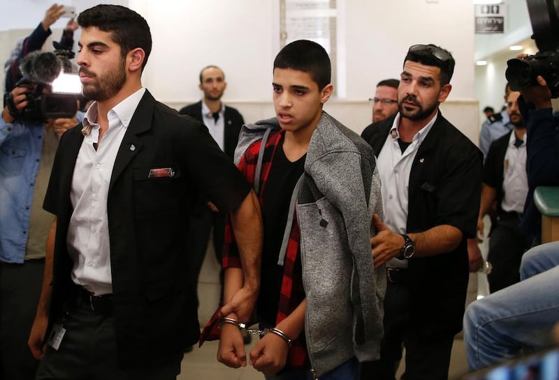 Ahmed Manasra, 14, leaves the district court in Jerusalem on November 7, 2016 after being sentenced to 12 years in jail for taking part in a knife attack on two Israelis in October, 2015. Ahmad Gharabli / AFP