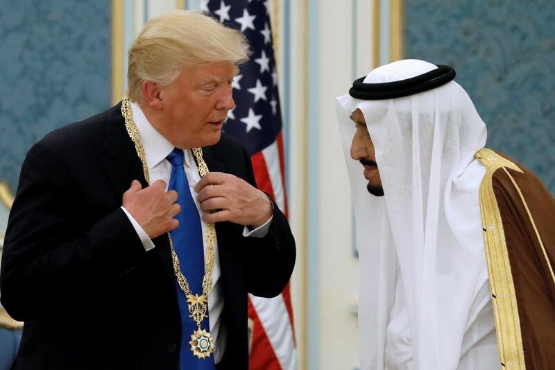 King Salman presents Mr Trump with the Collar of Abdulaziz Al Saud Medal at the Royal Court in Riyadh, Saudi Arabia May 20, 2017. Reuters/Jonathan Ernst