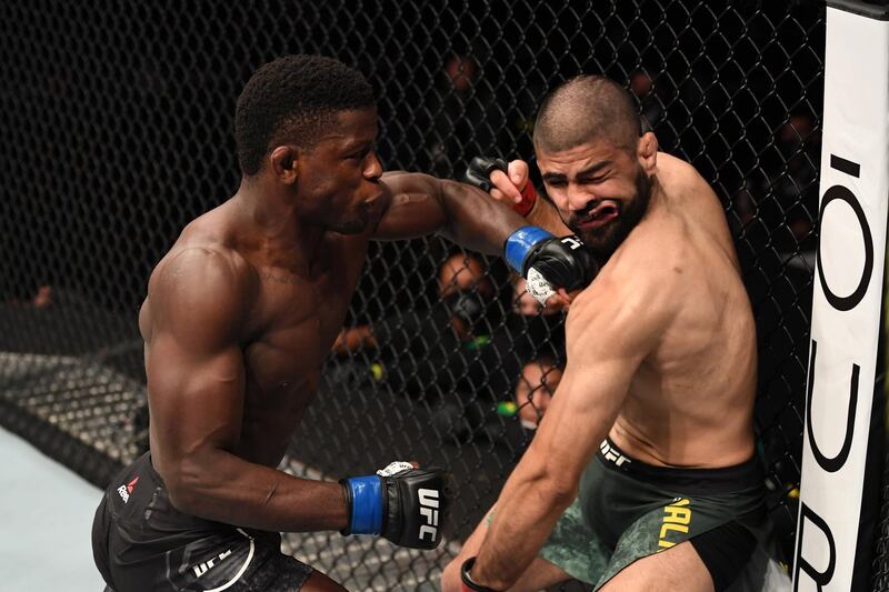 ABU DHABI, UNITED ARAB EMIRATES - OCTOBER 24:  (L-R) Phillip Hawes punches Jacob Malkoun of Australia in their middleweight bout during the UFC 254 event on October 24, 2020 on UFC Fight Island, Abu Dhabi, United Arab Emirates. (Photo by Josh Hedges/Zuffa LLC via Getty Images)