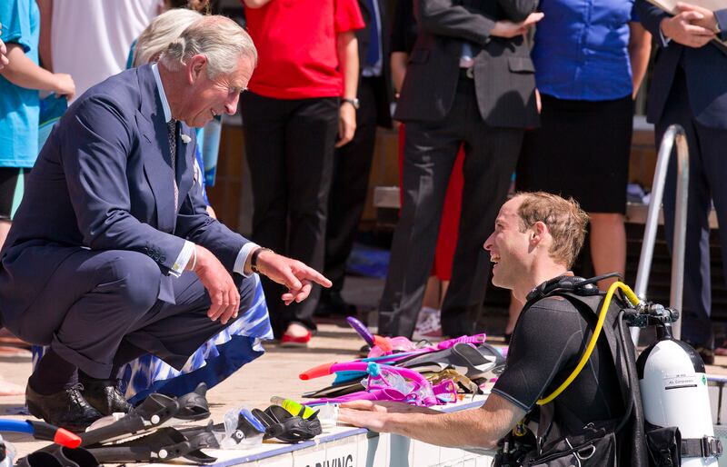 Prince Charles speaks to his son as he scuba dives with the British Sub-Aqua Club in July 2014 in London.