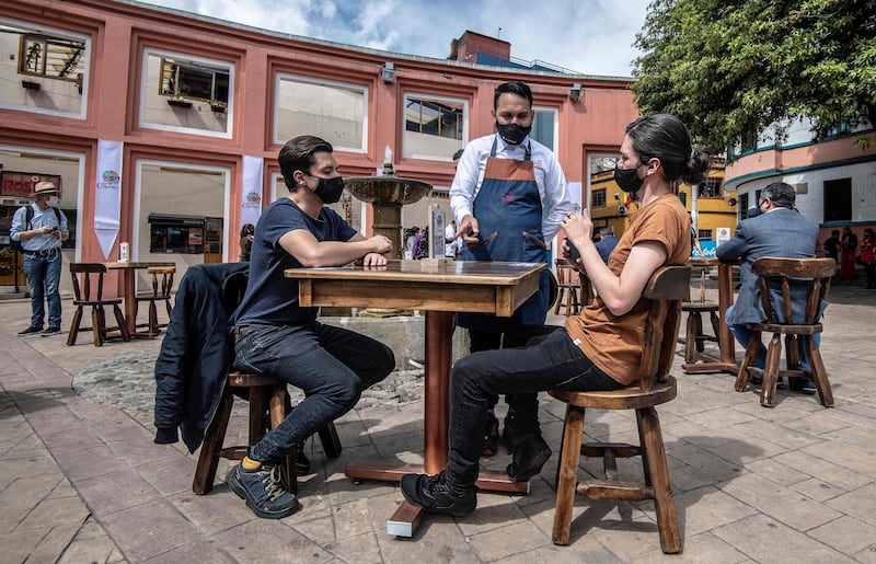 People participate at a pilot test of restaurant opening in Corro de Quevedo tourist area, in Bogota, Colombia. AFP