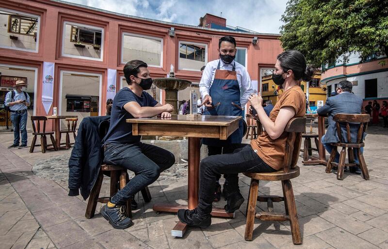 People participate at a pilot test of restaurant opening in Corro de Quevedo tourist area, in Bogota, Colombia. AFP