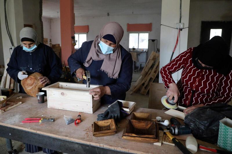 Palestinian women work at a carpenter workshop, established and run by a group of women, in the village of Al Walajeh near the West bank town of Bethlehem. AFP