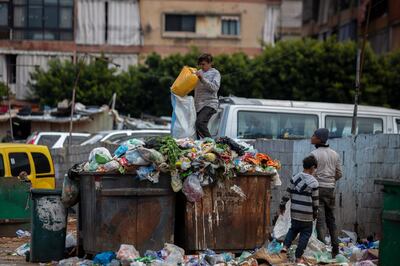 Children search for valuables in the garbage next to a market in Beirut, Lebanon, Monday, April 12, 2021. Muslims are facing their second Ramadan in the shadow of the pandemic. Many Muslim majority countries have been hit by an intense new coronavirus wave. While some countries imposed new Ramadan restrictions, concern is high that the month's rituals could stoke a further surge. (AP Photo/Hassan Ammar)