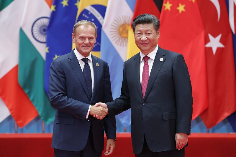 Chinese President Xi Jinping shakes hands with Mr Tusk at the G20 summit in Hangzhou, China, in 2016. Getty Images