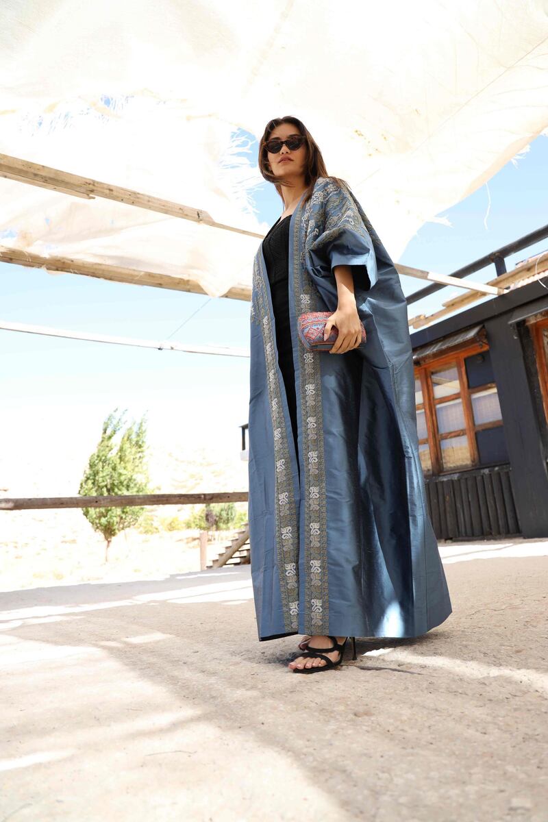 Inaash employs Palestinian women to decorate pieces with traditional embroidery, including this abaya and clutch. Courtesy Inaash.