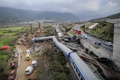 Police and emergency crews search the debris after the train accident. AFP