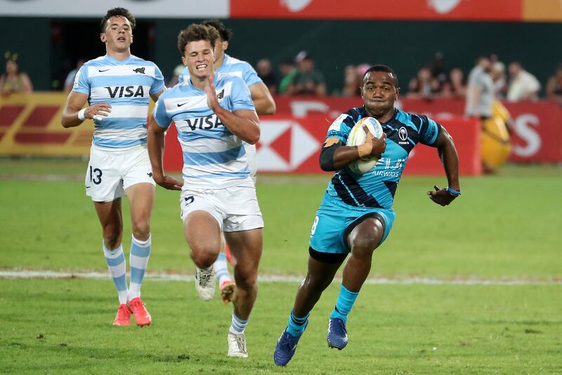 Players in action during the match between Fiji ( blue & black) vs Argentina (white & blue) held at The Sevens stadium on the second day of the Emirates Dubai Rugby Sevens series in Dubai. Pawan Singh/The National