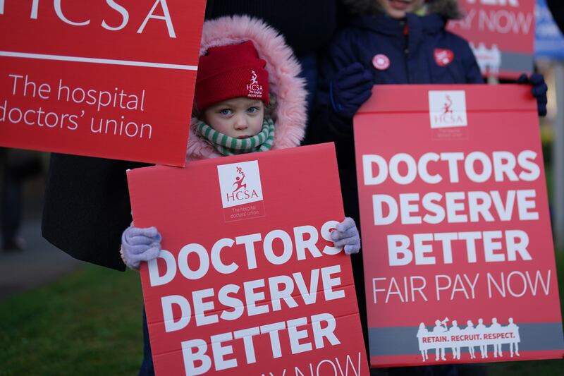 A child joins a picket line at the Leicester Royal Infirmary. PA