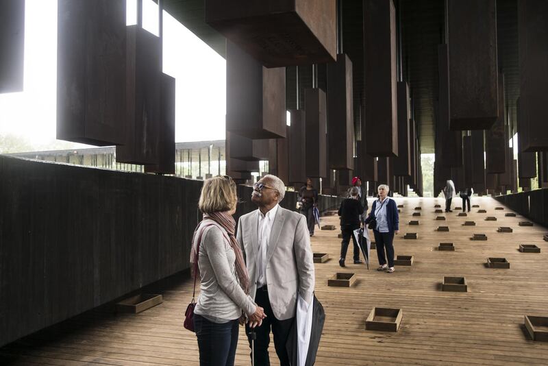 MONTGOMERY, AL - APRIL 26: Ed Sykes (center), 77, visits the National Memorial For Peace And Justice on April 26, 2018 in Montgomery, Alabama. Sykes, who has family in Mississippi, was distraught when he discovered his last name in the memorial, three months after finding it on separate memorial in Clay County, Mississippi. "This is the second time I've seen the name Sykes as a hanging victim. What can I say?" Sykes, who now lives in San Francisco, plans to investigate the lynching of a possible relative at the Equal Justice Initiative headquarters in Montgomery before returning to California. The memorial is dedicated to the legacy of enslaved black people and those terrorized by lynching and Jim Crow segregation in America. Conceived by the Equal Justice Initiative, the physical environment is intended to foster reflection on America's history of racial inequality.   Bob Miller/Getty Images/AFP