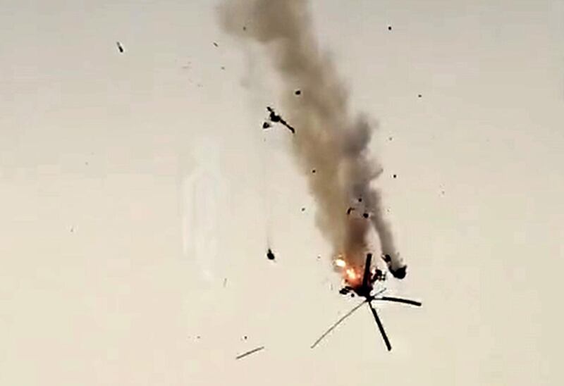 A Syrian government helicopter bursts in flames after it was hit by a missile in Idlib province on February 11, 2020. AFP