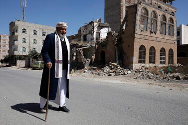 A Yemeni walks past a destroyed building in Sanaa, Yemen, February 5 2021. EPA