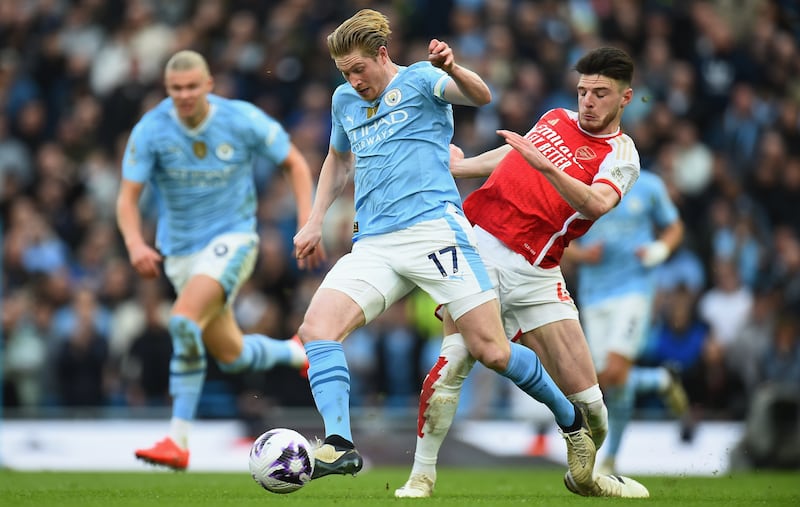 Manchester City's Kevin De Bruyne vies for the ball with Arsenal's Declan Rice during their Premier League match at the Etihad Stadium on Sunday, March 31, 2024. EPA