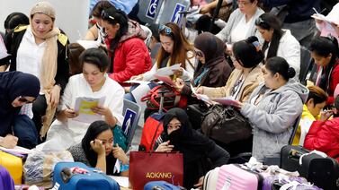 Filipino household workers, who were repatriated from Kuwait by their government, arrive in Manila in 2018. EPA