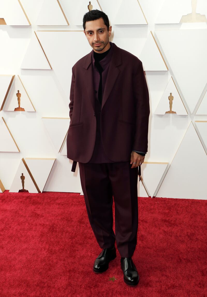 Riz Ahmed, wearing an oversized burgundy suit. EPA