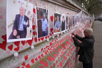Bereaved families mark one year of the National Covid Memorial Wall, in London, on March 29. PA Wire