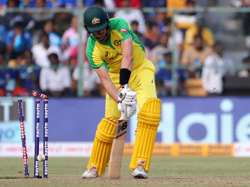 Australia batsman Pat Cummins is bowled out by India's Mohammed Shami. AP