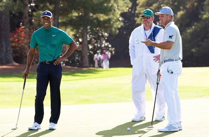 Bryson DeChambeau and Tiger Woods talk on the 18th green during a practice round prior to the Masters at Augusta National Golf Club. AFP