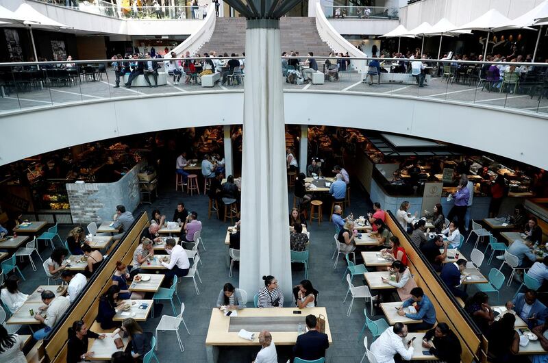 FILE PHOTO: Office workers take their lunch at a food court in Sydney, Australia May 4, 2018. REUTERS/Edgar Su/File Photo GLOBAL BUSINESS WEEK AHEAD