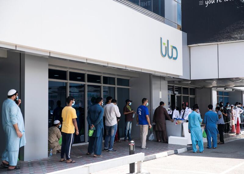 DUBAI, UNITED ARAB EMIRATES. 18 June 2020. 
Pakistani citizens who live in Dubai line up outside Dnata. They’ve received a confirmation call from the consulate regarding their repatriation flights. Some are flying back tonight.
(Photo: Reem Mohammed/The National)

Reporter:
Section: