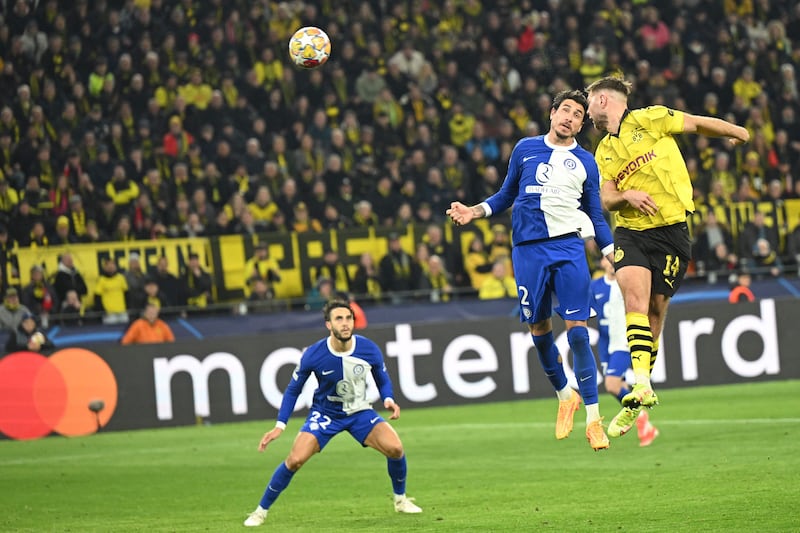 Niclas Fullkrug heads the ball to score Dortmund's third goal and level the tie against Atletico. AFP