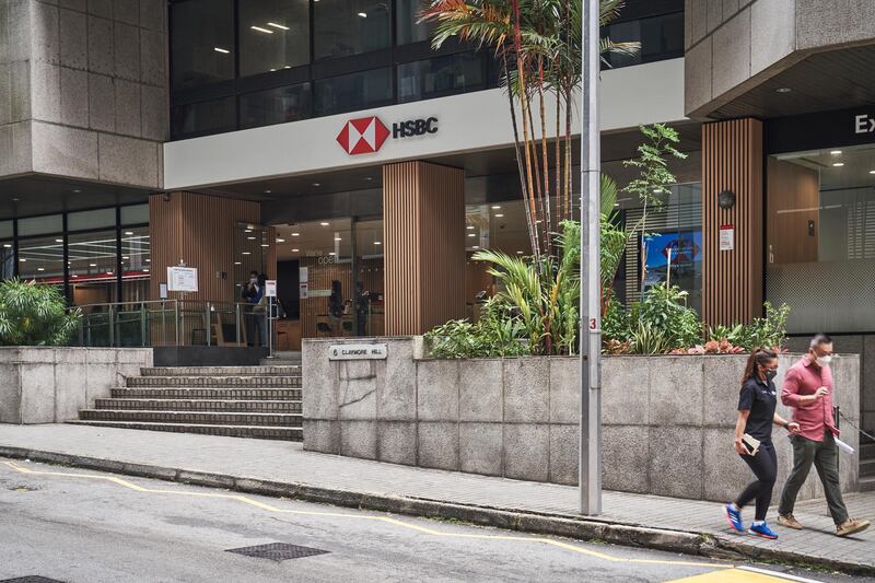 Pedestrians walk past a HSBC Holdings Plc bank branch in Singapore, on Thursday, Jan. 28, 2021. HSBC plans to accelerate its expansion across Asia in its imminent strategy refresh, Chairman Mark Tucker told the virtual Asian Financial Forum last week. Photographer: Lauryn Ishak/Bloomberg