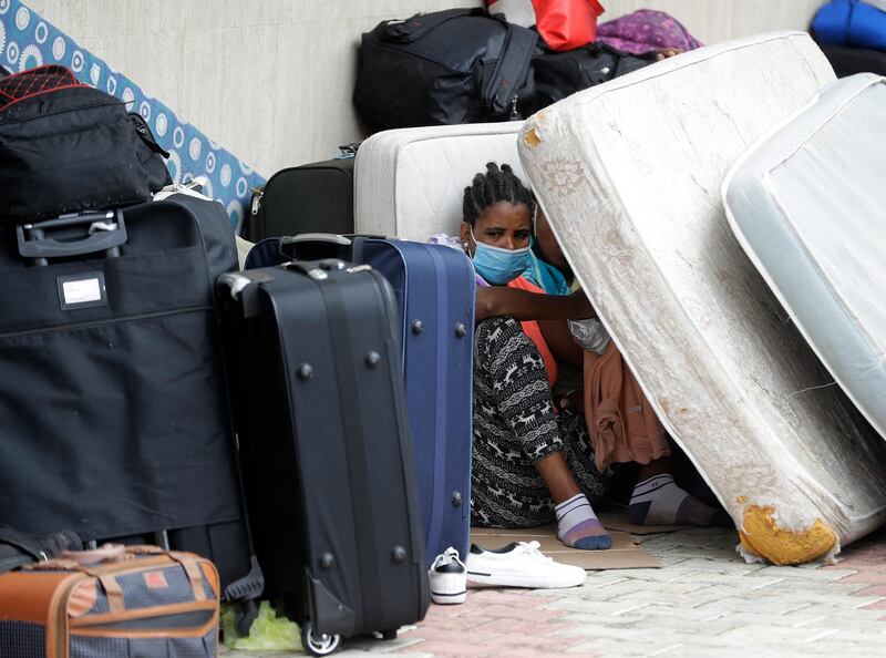 Ethiopian domestic workers who were dismissed by their employers gather with their belongings outside their country’s embassy in Hazmiyeh, east of Beirut, on June 24, 2020. - Around 250,000 migrants -- usually women -- work as housekeepers, nannies and carers in Lebanese homes, a large proportion Ethiopian and some for as little as $150 a month. None are protected by the labour law. (Photo by JOSEPH EID / AFP)