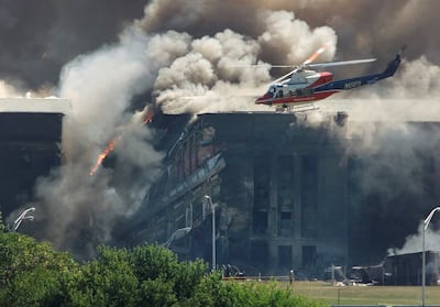 A rescue helicopter surveys damage to the Pentagon in Washington as firefighters battle the flames on September, 11 2001. Reuters
