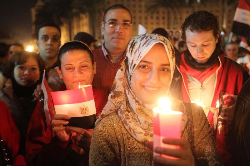 Thousands of Egyptian Muslims and Coptic Christians attend a celebration on New Year's eve in Tahrir Square in Cairo, on December 31, 2011, as they remember those killed in the revolution that ended the long reign of president Hosni Mubarak. TOPSHOTS    AFP PHOTO / KHALED DESOUKI
 *** Local Caption ***  560376-01-08.jpg