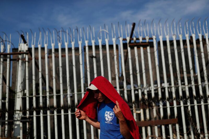 A migrant stands in front of the fortified border gate between Guatemala and Mexico, in Tecun Uman, Guatemala. Reuters