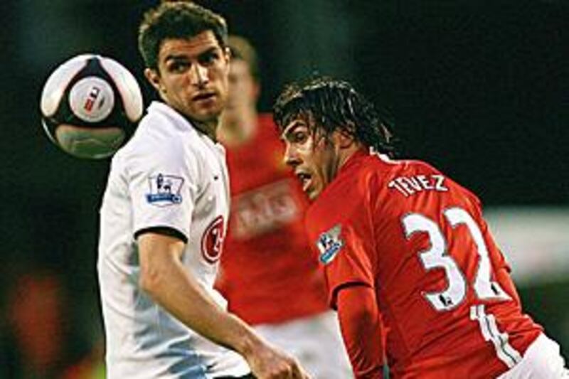 The movement and energy of Carlos Tevez, right, was too much to handle for Aaron Hughes, left, and Fulham.