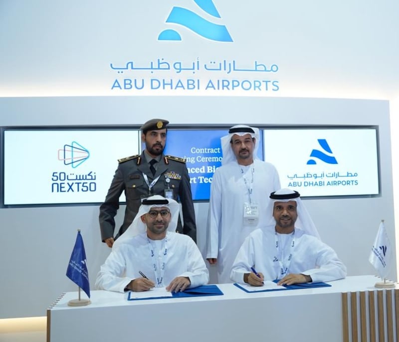 Ibrahim Al Mannaee, chief executive of Next50, left, and Jamal Salem Al Dhaheri, chief executive of Abu Dhabi Airports, sign an agreement to introduce facial recognition that will allow travellers at Abu Dhabi International Airport to check in, clear immigration, enter lounges and board flights using only biometric data. Photo: Next50