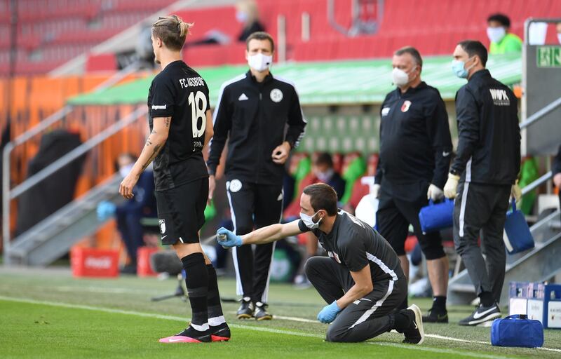 Augsburg's Tin Jedvaj receives  treatment during match. Getty