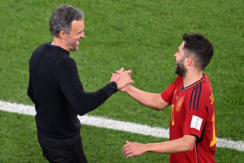 Spain's coach Luis Enrique congratulates Jordi Alba during the match. AFP