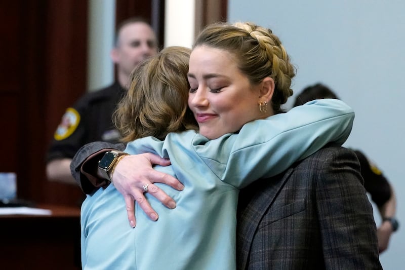 US actress Amber Heard hugs a member of her legal team. EPA