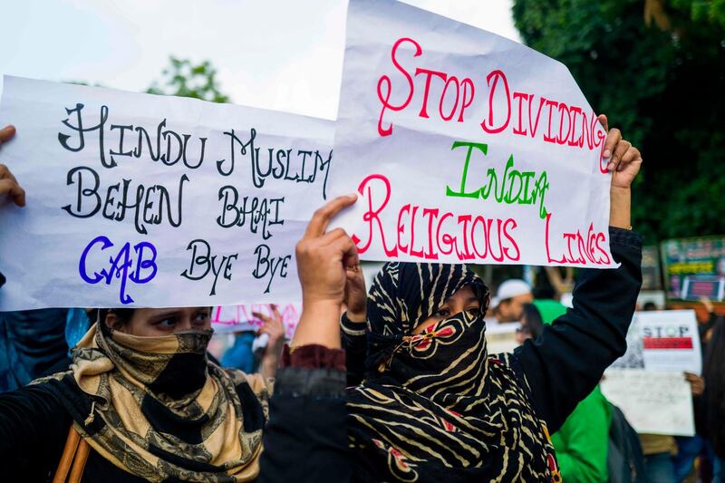 Protesters display placards during a demonstration against the Indian government's Citizenship Amendment Bill in New Delhi.  AFP