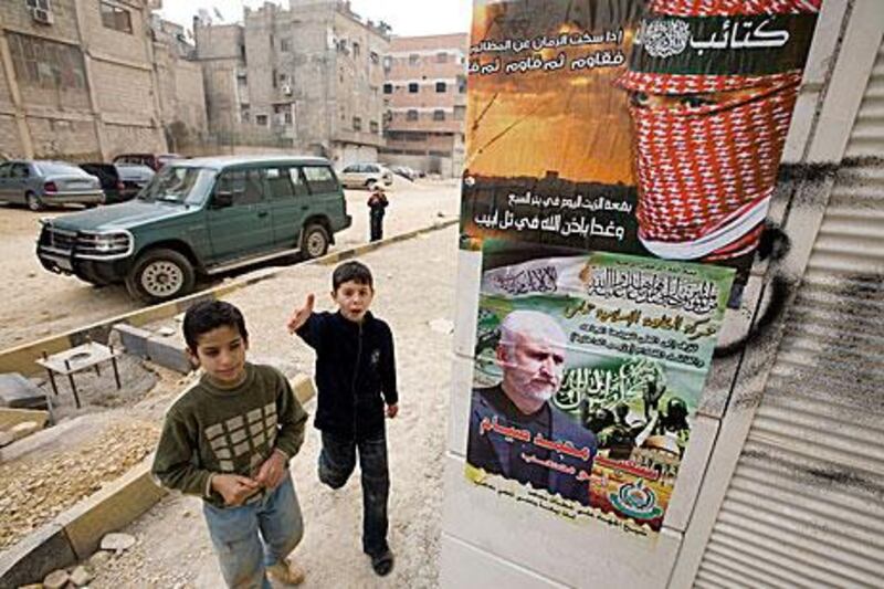 Hamas posters hang on a wall outside their main Damascus administrative office near Yarmouk Camp in January 2009.