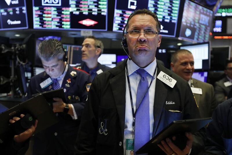 Trader Edward Curran works on the floor of the New York Stock Exchange, Tuesday, June 18, 2019. Stocks are opening higher on Wall Street following big gains in Europe after the head of the European Central Bank said it was ready to cut interest rates and provide more economic stimulus if necessary. (AP Photo/Richard Drew)