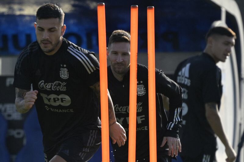 Argentina forward Lionel Messi and midfielder Leandro Paredes warm up. AFP