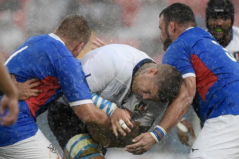 Italy prop Marco Riccioni, centre, attempts to run with the ball against Namibia at the Hanazono Rugby Stadium in Higashiosaka. AFP