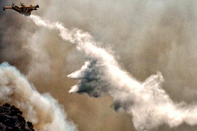 A firefighting plane tries to extinguish a wildfire near the village of Kehries, in Peloponesae area, near Corinth in Greece. AFP