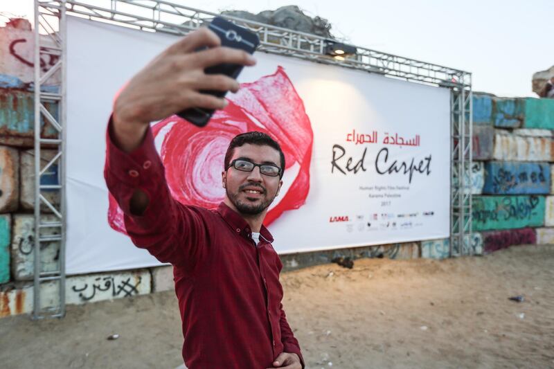 GAZA CITY, GAZA - MAY 12: Palestinian young man takes a selfie during the 3th edition of the Red Carpet Film Festival in Gaza City, Gaza on May 12, 2017. (Photo by Mustafa Hassona/Anadolu Agency/Getty Images)
