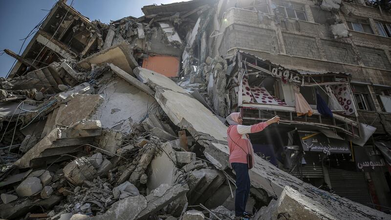 A Palestinian girl takes selfie with her mobile amid the rubble of the destroyed Al Shorouq tower after a ceasefire between Israel and Palestinian fighters, in Beit Hanoun, the northern Gaza Strip. EPA