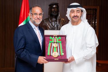 Sheikh Abdullah bin Zayed, Minister of Foreign Affairs and International Co-operation, presents the Order to the Navdeep Suri, outgoing Indian ambassador to the UAE, during a meeting at the ministry in Abu Dhabi on Monday. Wam